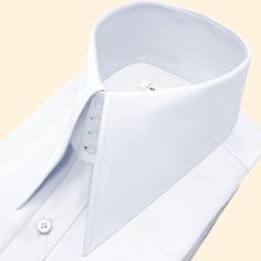 High Long Pointed Collar Tailor-Made On Order shirt 𝘈 𝘸𝘩𝘪𝘵𝘦 𝘩𝘪𝘨𝘩-𝘤𝘰𝘭𝘭𝘢𝘳 𝘴𝘩𝘪𝘳𝘵 𝘪𝘴 𝘢 𝘤𝘭𝘢𝘴𝘴𝘪𝘤 𝘢𝘯𝘥 𝘵𝘪𝘮𝘦𝘭𝘦𝘴𝘴 𝘸𝘢𝘳𝘥𝘳𝘰𝘣𝘦 𝘴𝘵𝘢𝘱𝘭𝘦 𝘵𝘩𝘢𝘵 𝘦𝘹𝘶𝘥𝘦𝘴 𝘴𝘰𝘱𝘩𝘪𝘴𝘵𝘪𝘤𝘢𝘵𝘪𝘰𝘯 𝘢𝘯𝘥 𝘦𝘭𝘦𝘨𝘢𝘯𝘤𝘦. 𝘛𝘩𝘪𝘴 𝘵𝘺𝘱𝘦 𝘰𝘧 𝘴𝘩𝘪𝘳𝘵 𝘧𝘦𝘢𝘵𝘶𝘳𝘦𝘴 𝘢 𝘤𝘰𝘭𝘭𝘢𝘳 𝘵𝘩𝘢𝘵 𝘴𝘵𝘢𝘯𝘥𝘴 𝘶𝘱 𝘢𝘯𝘥 𝘦𝘯𝘤𝘪𝘳𝘤𝘭𝘦𝘴 𝘵𝘩𝘦 𝘯𝘦𝘤𝘬, 𝘱𝘳𝘰𝘷𝘪𝘥𝘪𝘯𝘨 𝘢 𝘳𝘦𝘧𝘪𝘯𝘦𝘥 𝘢𝘯𝘥 𝘱𝘰𝘭𝘪𝘴𝘩𝘦𝘥 𝘭𝘰𝘰𝘬. 𝘛𝘩𝘦 𝘤𝘳𝘪𝘴𝘱 𝘸𝘩𝘪𝘵𝘦 𝘤𝘰𝘭𝘰𝘳 𝘰𝘧 𝘵𝘩𝘦 𝘴𝘩𝘪𝘳𝘵 𝘪𝘴 𝘷𝘦𝘳𝘴𝘢𝘵𝘪𝘭𝘦 𝘢𝘯𝘥 𝘱𝘢𝘪𝘳𝘴 𝘸𝘦𝘭𝘭 𝘸𝘪𝘵𝘩 𝘢 𝘷𝘢𝘳𝘪𝘦𝘵𝘺 𝘰𝘧 𝘴𝘵𝘺𝘭𝘦𝘴 𝘢𝘯𝘥 𝘤𝘰𝘭𝘰𝘳𝘴, 𝘮𝘢𝘬𝘪𝘯𝘨 𝘪𝘵 𝘢𝘯 𝘪𝘥𝘦𝘢𝘭 𝘤𝘩𝘰𝘪𝘤𝘦 𝘧𝘰𝘳 𝘣𝘰𝘵𝘩 𝘧𝘰𝘳𝘮𝘢𝘭 𝘢𝘯𝘥 𝘤𝘢𝘴𝘶𝘢𝘭 𝘰𝘤𝘤𝘢𝘴𝘪𝘰𝘯𝘴. 𝘛𝘩𝘦 𝘴𝘩𝘪𝘳𝘵 𝘪𝘴 𝘵𝘺𝘱𝘪𝘤𝘢𝘭𝘭𝘺 𝘮 Solid Business Tops With Collar, White Collared Business Top, Luxury White Semi-formal Top, White Business Shirt With Fold Down Collar, White Fold Down Collar Shirt For Business, White Business Tops With Fold Down Collar, White Business Top With Fold Down Collar, Luxury Business Tops With Collar, Luxury White Office Tops