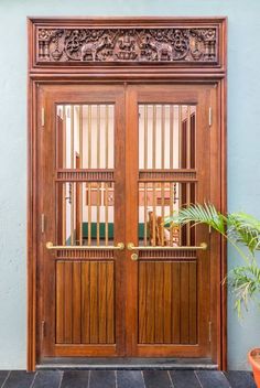 a large wooden door with glass panels on it