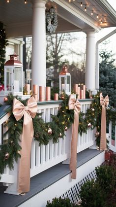 a porch decorated for christmas with pink and gold decorations on the railing, lights and garlands