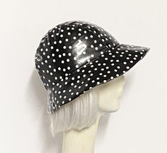 Cloche Rain Hat- Black and White Polka Dots, lined in black taffeta, the hat has a 3 section fitted top and a one piece brim. and has a 1" soft elastic band inside. One size fits most up to 22" Made in USA Hand wash /dry Fitted Bucket Mini Hats For Kentucky Derby, Retro Fitted Brimmed Mini Hats, Retro Black Brimmed Bucket Hat, Rain Hat, Fitted Top, White Polka Dot, Workout Tops, Elastic Band, Made In Usa