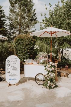 an ice cream cart with flowers and umbrellas