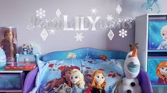 a bedroom with frozen princess bedding and toys on the nightstands in front of it