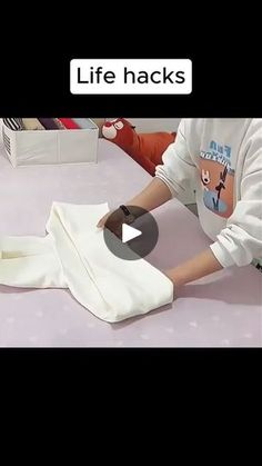 a person is cutting fabric with scissors on a white tablecloth that says life hacks