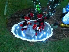 two stuffed animals sitting on top of a snow globe