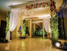 an indoor wedding venue decorated with flowers and greenery