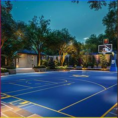 an outdoor basketball court is lit up at night with trees and bushes in the background