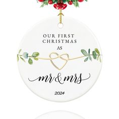 a personalized ornament for the first christmas as mr and mrs on a white background