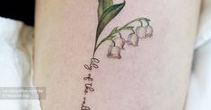 lily of the valley tattoo on the right thigh with words written in cursive font