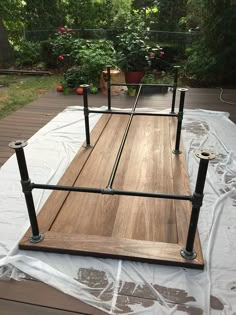 a wooden platform with metal rails on it