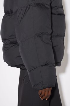 Acne Studios black regular fit down jacket has a high neck and Acne Studios branding at the chest. FN-WN-OUTW000678 Black Duck Down Puffer Jacket, Functional Black Duck Down Puffer Jacket, Black Duck Down Puffer Jacket With Pockets, Fitted Black Duck Down Outerwear, Black Duck Down Puffer Jacket For Fall, Urban Black Duck Down Outerwear, Black Puffer Jacket With Detachable Hood, Black Down Puffer Jacket With Padded Collar, Urban Black Duck Down Puffer Jacket