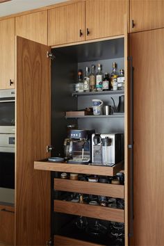 an open cabinet in a kitchen with spices and condiments