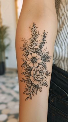 Intricate floral forearm tattoo design showcasing botanical elements for nature lovers. Wildflower Forearm Sleeve, Wildflower Floral Tattoo, Floral Forearm Tattoo Design, Floral Tattoos Forearm, Forarm Tattoos Woman Floral, Flower Bouquet Tattoo Sleeve, Inner Forearm Tattoo Flowers, Feminine Floral Sleeve Tattoo, Floral Tattoo Filler Ideas