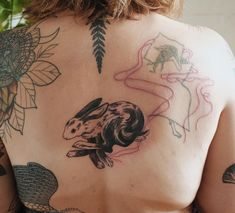 a woman with tattoos on her back and chest