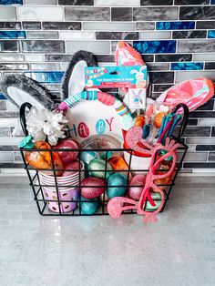 a basket filled with lots of assorted items in front of a tile backsplash