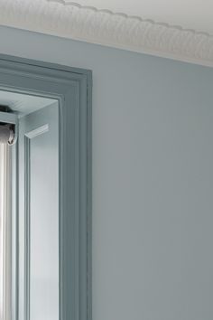 a bathroom mirror sitting on top of a white wall next to a window sill