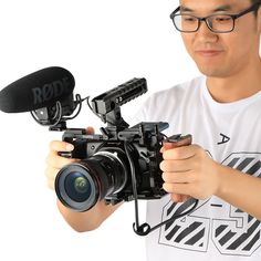 a man holding a camera and recording something