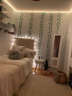 a bed room with a neatly made bed and string lights on the wall above it