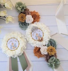 some flowers are laying on the table with ribbons and tags attached to each flower headband