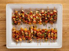 skewered vegetables and meat on a white plate