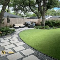 a backyard with grass and stone walkway