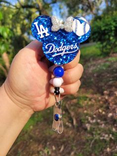 someone is holding up a dodgers key chain