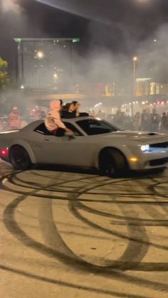 two people riding in the back of a white car