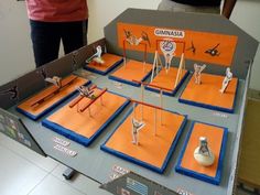 a table topped with lots of different types of figurines on top of orange trays