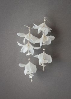 Much loved for its feminine details, these floral bridal earrings are distinguished by its slender and delicate Willow-like silhouette. Floral Bridal Earrings, Whimsical White Wedding Earrings, Chic White Flower Wedding Earrings, Nature-inspired Flower Earrings For Wedding, Elegant Flower-shaped Bridal Earrings, Delicate White Flower-shaped Bridal Earrings, Wedding Earrings Bride, Wearable Flowers, Embellished Veil