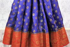 Traditional dark blue Muga Banarasi saree for weddings, parties and festive occasions! The antique zari work on the red border and pallu along with buta makes the saree absolutely rich. It comes with a matching red blouse piece. Buy this traditional saree online at Pure Elegance or visit our store in USA! Disclaimer: The actual product may vary slightly from the image. These are custom orders, hence expect slight variation in color, placement of the motif or buta. ESTIMATED DELIVERYBecause this is a custom order, it would take about 4 weeks from the date of purchase. RETURN POLICYThis product is a custom order and cannot be returned or exchanged. Banarasi Sari, Indian Handloom, Elegance Fashion, Fashion Journals, Red Border, Pure Elegance, Traditional Saree, Red Blouse, Traditional Fabric