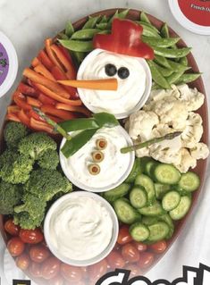 a snowman made out of vegetables and dips on a platter with the words good food written below it