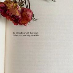 an open book with flowers on the pages and a quote written in it that says, to fall in love with their soul before ever touching their skin