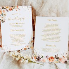 two wedding programs with gold lettering and flowers