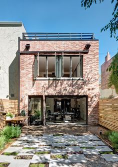 a brick house with an outdoor patio and seating area