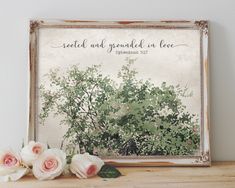 there is a picture frame with flowers on the table next to it and an inscription that reads, loved and grounded as love