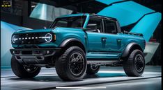 a blue ford bronco pickup truck on display