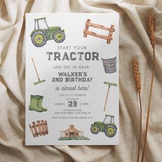 a tractor themed birthday party card on a bed with white sheets and brown straws