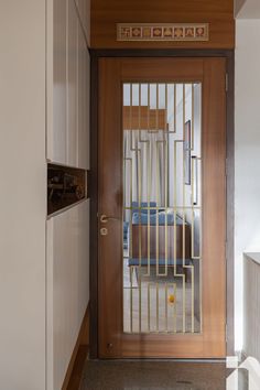 a wooden door with bars on it in a hallway next to a counter and cabinets