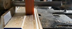 a piece of wood being worked on by a machine