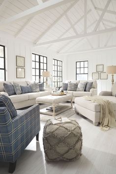 a living room filled with furniture and windows