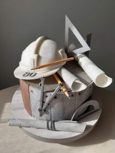 a cake made to look like a construction site with tools on top and the shape of a helmet