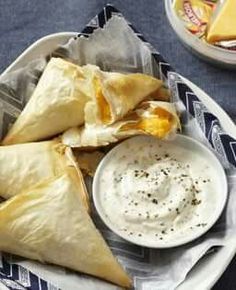 some food on a plate with dip and cheese