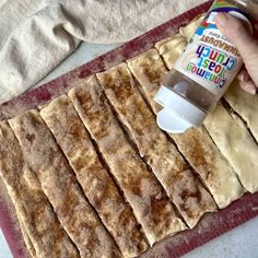 a person is spreading icing on some flat bread