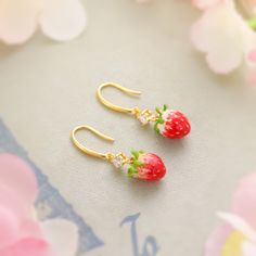 Indulge in the sweetness of these luscious strawberry earrings. Featuring a delicate enamel finish and shimmering cubic zirconia, these cheerful earrings brighten up your look with a touch of nature-inspired style. Perfect for adding a pop of freshness and fashion to your summer vibes! DETAILS Plating: 18K Gold Materials: 18K Gold on Brass, Enamel, Cubic Zirconia Size: 1.39 "*0.39"(3.4c m*1cm) Weight: 6.4g Sweet Drop Earrings As A Gift, Sweet Drop Earrings For Gift, Sweet Drop Earrings Jewelry Gift, Cute Fruit Design Earrings For Gift, Cute Fruit Design Earrings, Sweet Jewelry With Fruit Design For Gift, Fruit Design Drop Earrings As Gift, Fruit Design Drop Earrings For Gift, Gold Earrings With Fruit Design For Gift