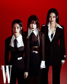 three women dressed in black and white are posing for a photo against a red background