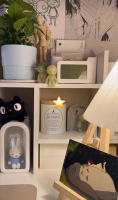 a white shelf with various items on it and a lamp next to the shelves in front of them