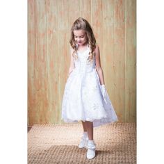 A great, elegant dress from Rain Kids for making the moment unique on that big day when she'll participate at her Christening. The bottom ruffle part of the skirt is detachable to give the option for a long gown or a short dress. The short dress has a Virgin Mary embroidered on the front center and a beautiful long tail in the back. Corset on the sides to adjust for size. Matching jacket included. What a perfect dress for both the day and the night occasion! Fitted Tulle First Communion Dress With Ruffles, Fitted White Organza Pageant Dress, First Communion Dress With Lace Bodice, Fitted Princess Organza First Communion Dress, Fitted Organza Princess First Communion Dress, Fitted Organza Princess Dress For First Communion, Fitted Princess Style Organza First Communion Dress, White Princess Dress With Ruffles And Fitted Bodice, White Princess Dress With Fitted Bodice And Ruffles