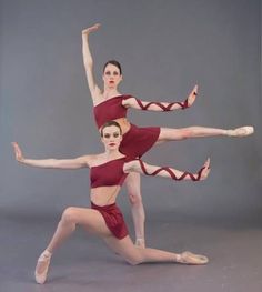 two ballerinas are posing for a photo in their red leorboam outfits