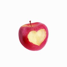 an apple with a heart cut out of it's side on a white background