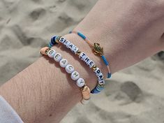 Trendy chunks of clay heishi beads with gold accent beads and durable elastic cord make up this adorable bracelet set that is perfect for any beach lover! Choose from 1 - 6 colors, gold or silver accent beads, and size. I also have the round letters available in white with silver letters as well. These accent beads shown on the "Beachy" bracelet are non-magnetic synthetic hematite that is platinum plated and golden plated. The turtle bracelet is made with a Tibetian Gold Turtle bead made out of Gold Beaded Bracelets With Letter Beads For Vacation, Gold Beaded Bracelets With Letter Beads For Beach, Letter Beads Beaded Bracelet For Beach Vacation, Beachy Adjustable Beaded Bracelets With Letter Beads, Adjustable Stretch Bracelet With Letter Beads For Vacation, Adjustable Letter Beads Stretch Bracelet For Vacation, Adjustable Beachy Beaded Bracelets With Letter Beads, Beachy Friendship Bracelets With Letter Beads, Gold Heishi Beaded Bracelets For Vacation