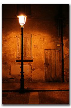 a street light in front of an old building